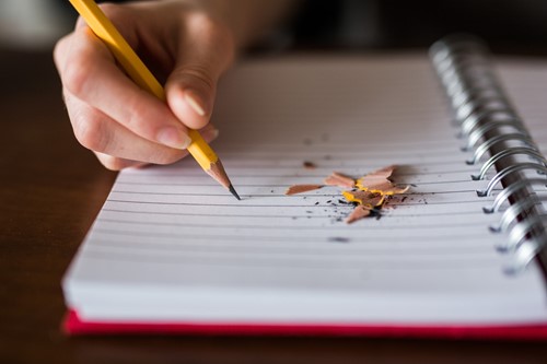 person writing in notebook